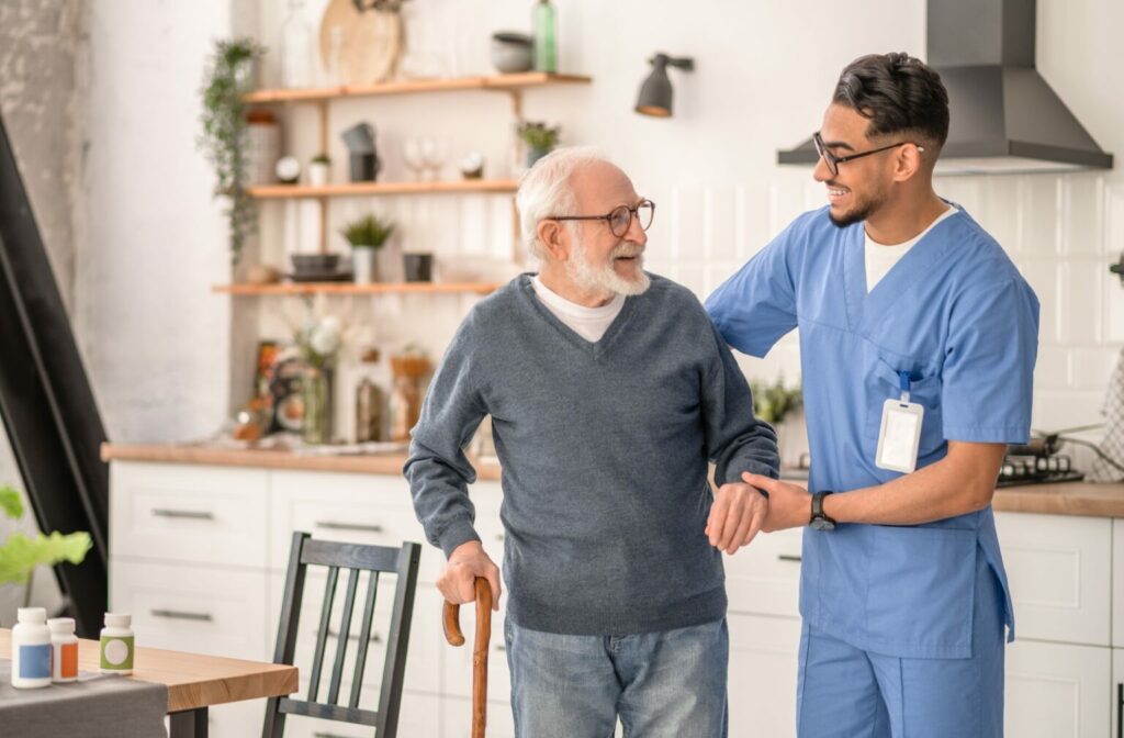 caregiver helping a senior to walk with a cane in home healthcare