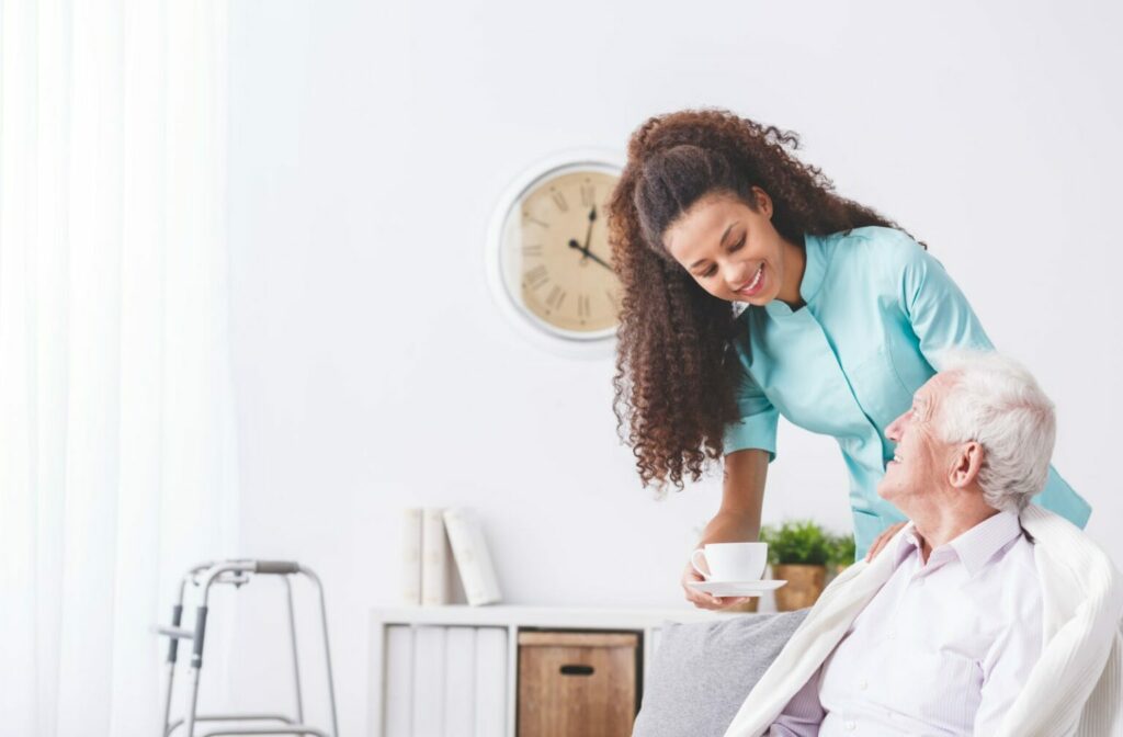 a caregiver bringing cup of tea to a senior in home healthcare