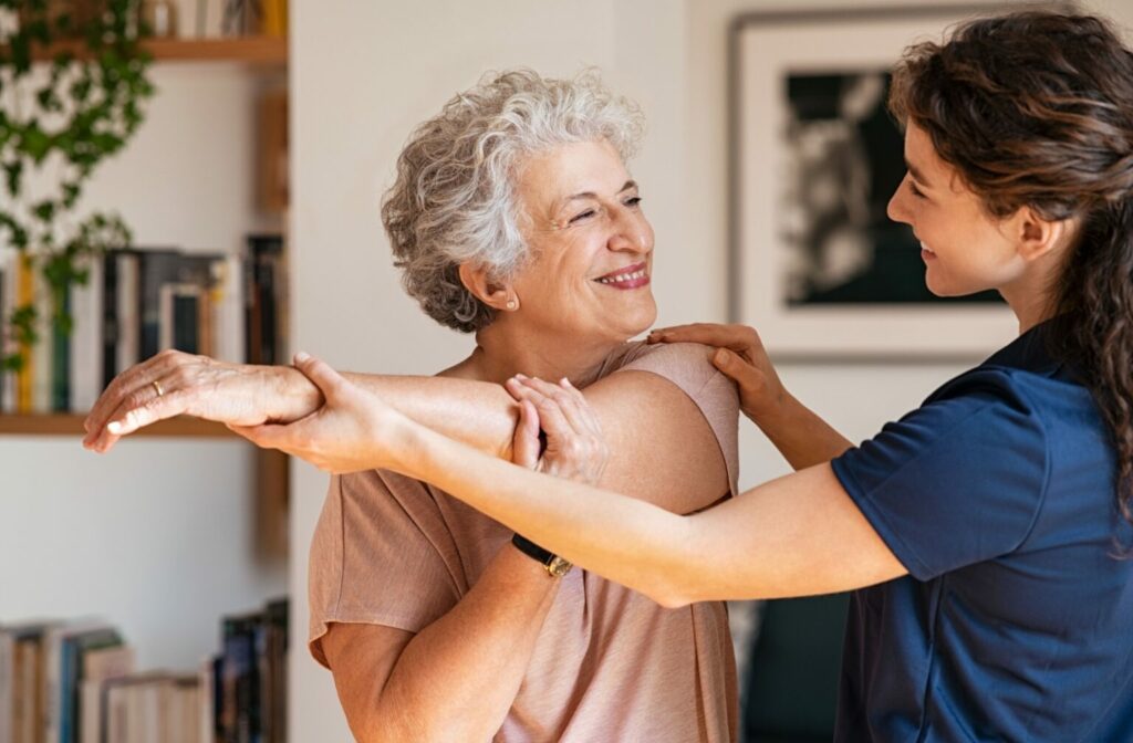 a caregiver helping senior with her rehabilitation