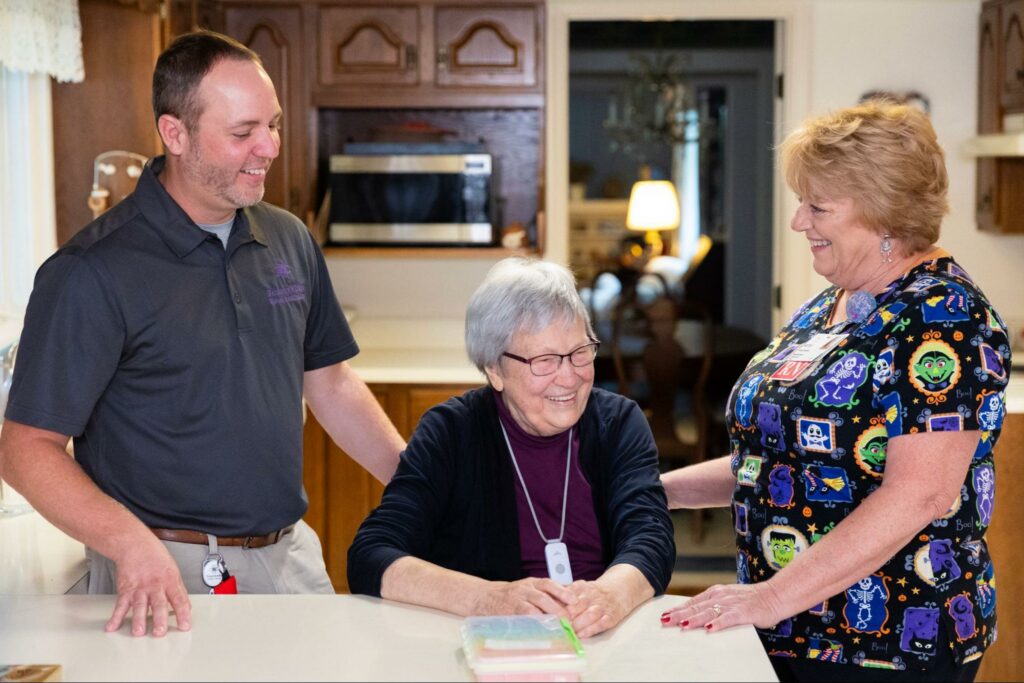 two home healthcare workers support a senior in their home